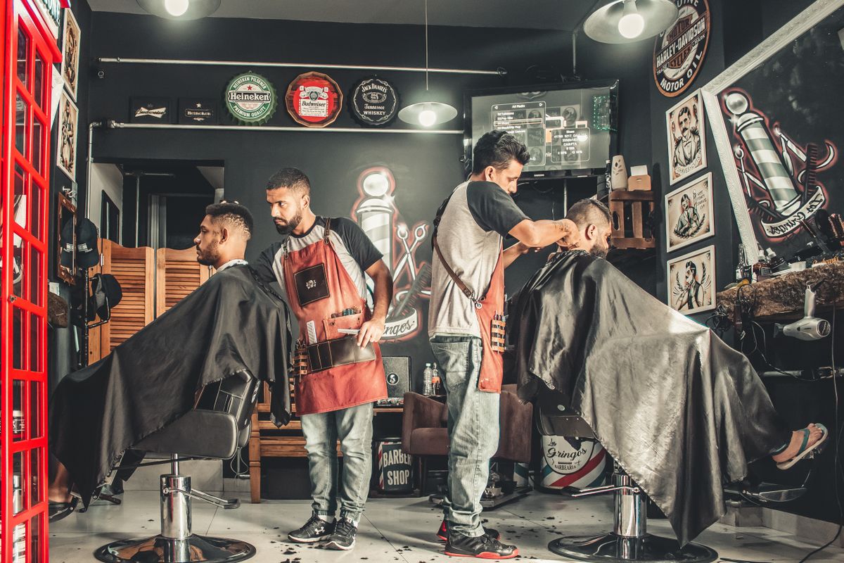 Barber completing a male client's hair styling